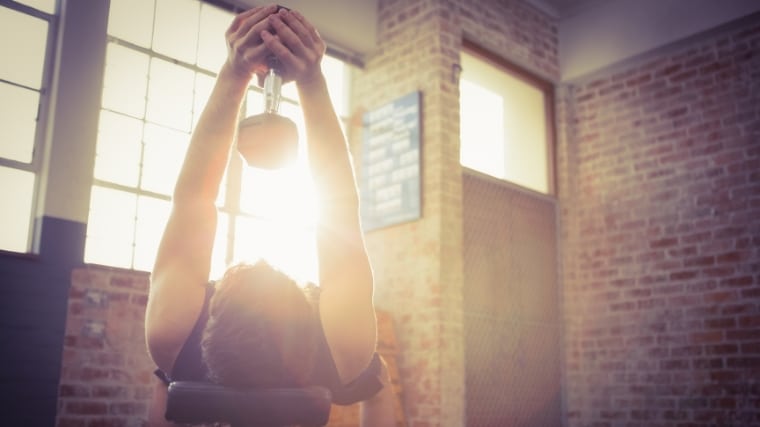 A person doing dumbbell pullovers.